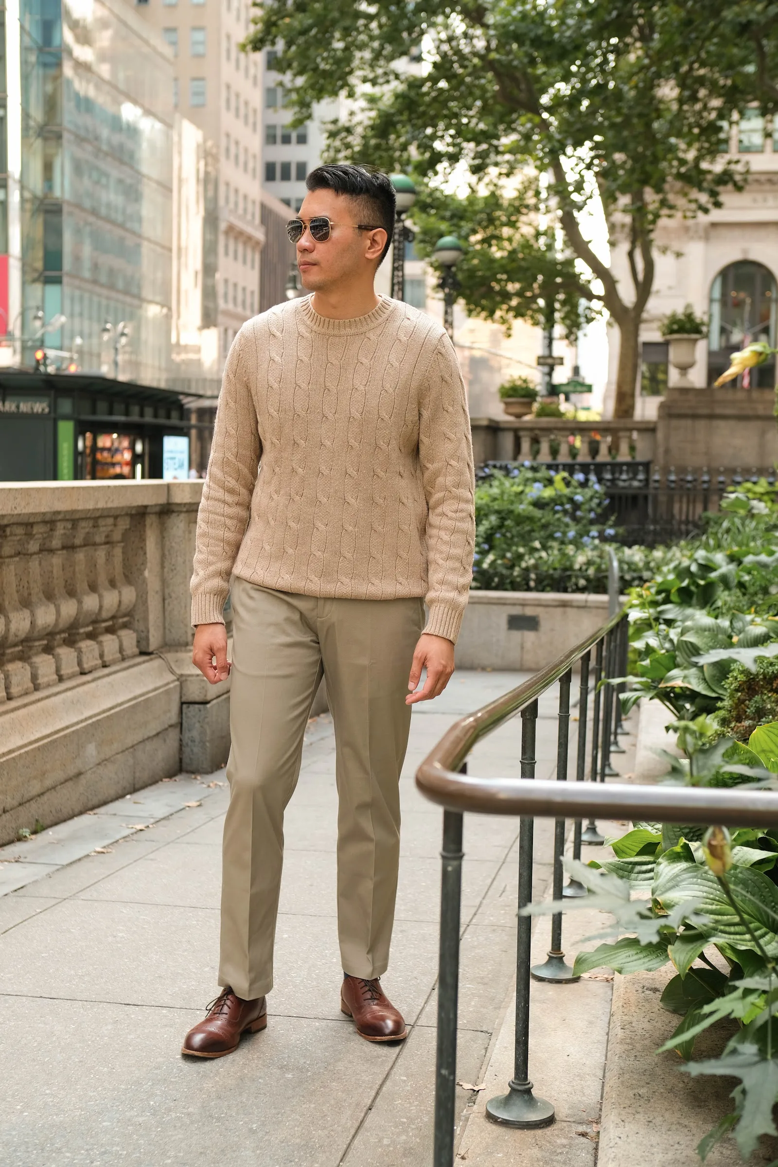 Instagram Influencer Marketing Agency 67 Influencer in a Haggar knit sweater on a stone plaza