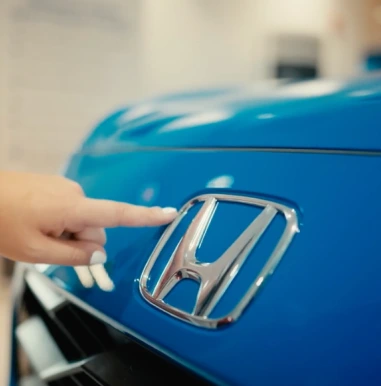 TikTok Influencer Marketing Agency 53 Creator pointing to the Honda badge on a Certified Pre-Owned car